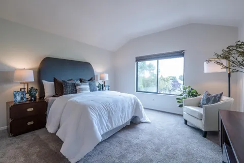 a bedroom with a bed and a couch