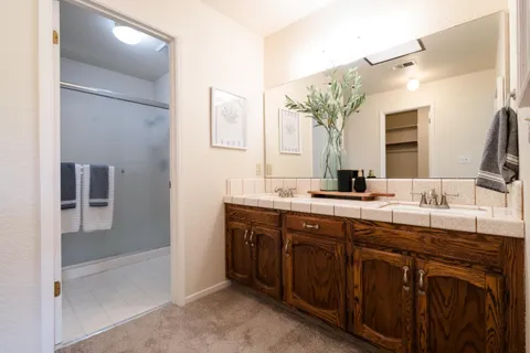a bathroom with a double vanity sink and a mirror