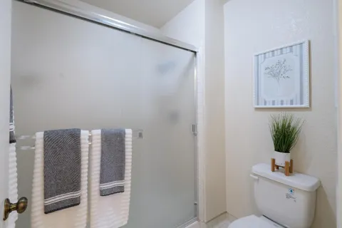 a bathroom with a toilet and a shower curtain