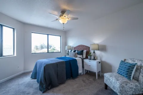 a bed room with a bed and a chandelier
