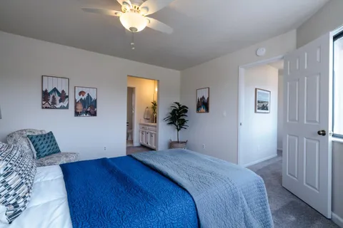 a bedroom with a bed and a chandelier