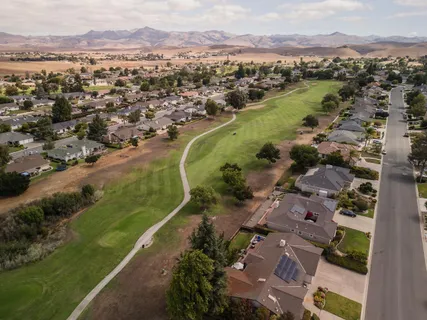 an aerial view of a city with mountains