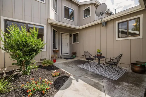 a view of a backyard with sitting area