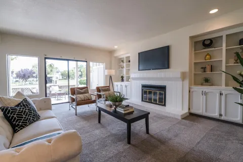 a living room with furniture fireplace and window