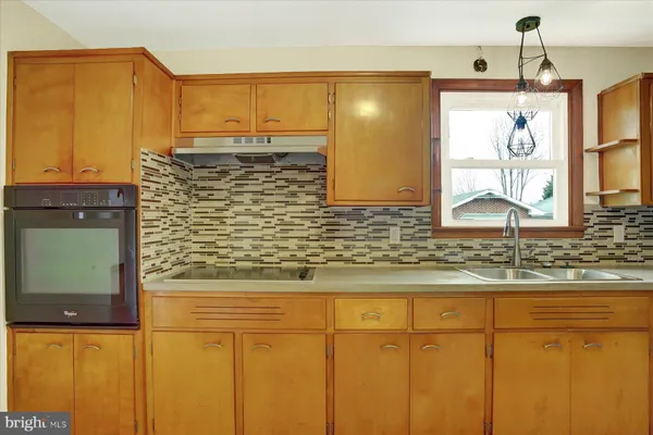 a bathroom with a granite countertop window and a sink
