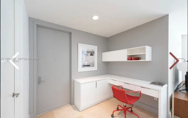 a bedroom with a large bed and a night stand
