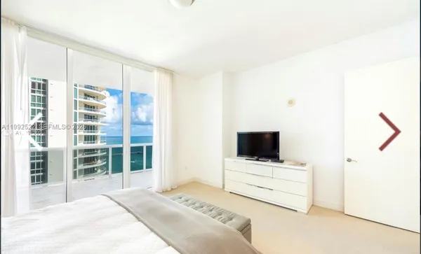 a bedroom with bed and window