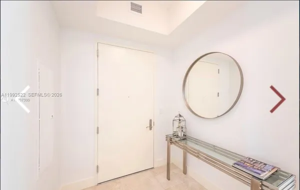a living room with furniture a flat screen tv and a large window