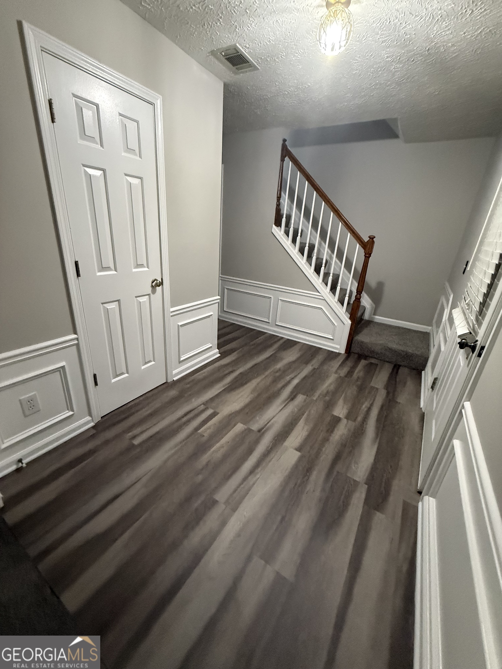 4144 Pinehurst Valley Drive Decatur, GA 30034 - Photo 2 of 31 a view of a hallway with wooden floor and staircase