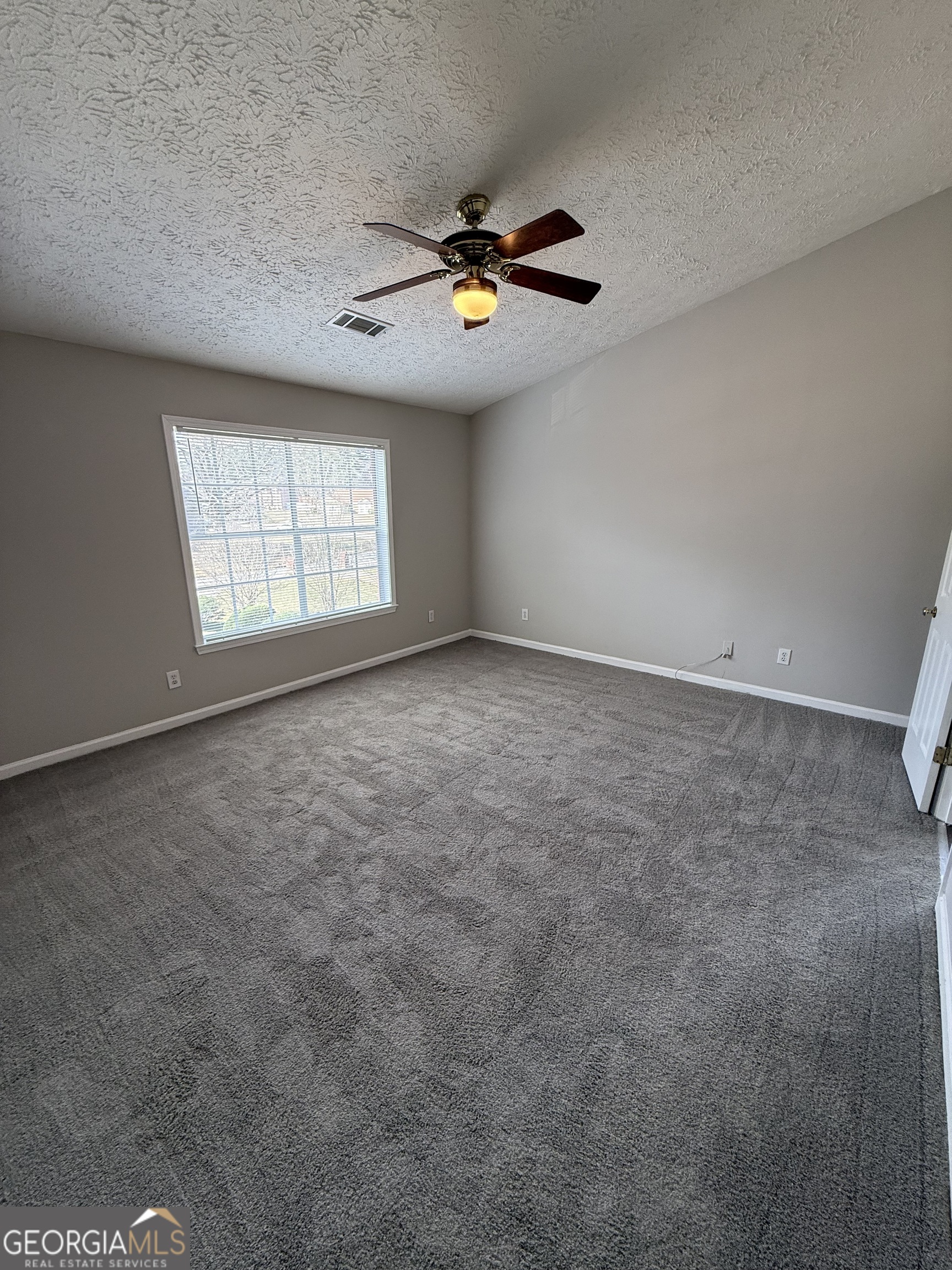 4144 Pinehurst Valley Drive Decatur, GA 30034 - Photo 25 of 31 an empty room with windows and chandelier fan