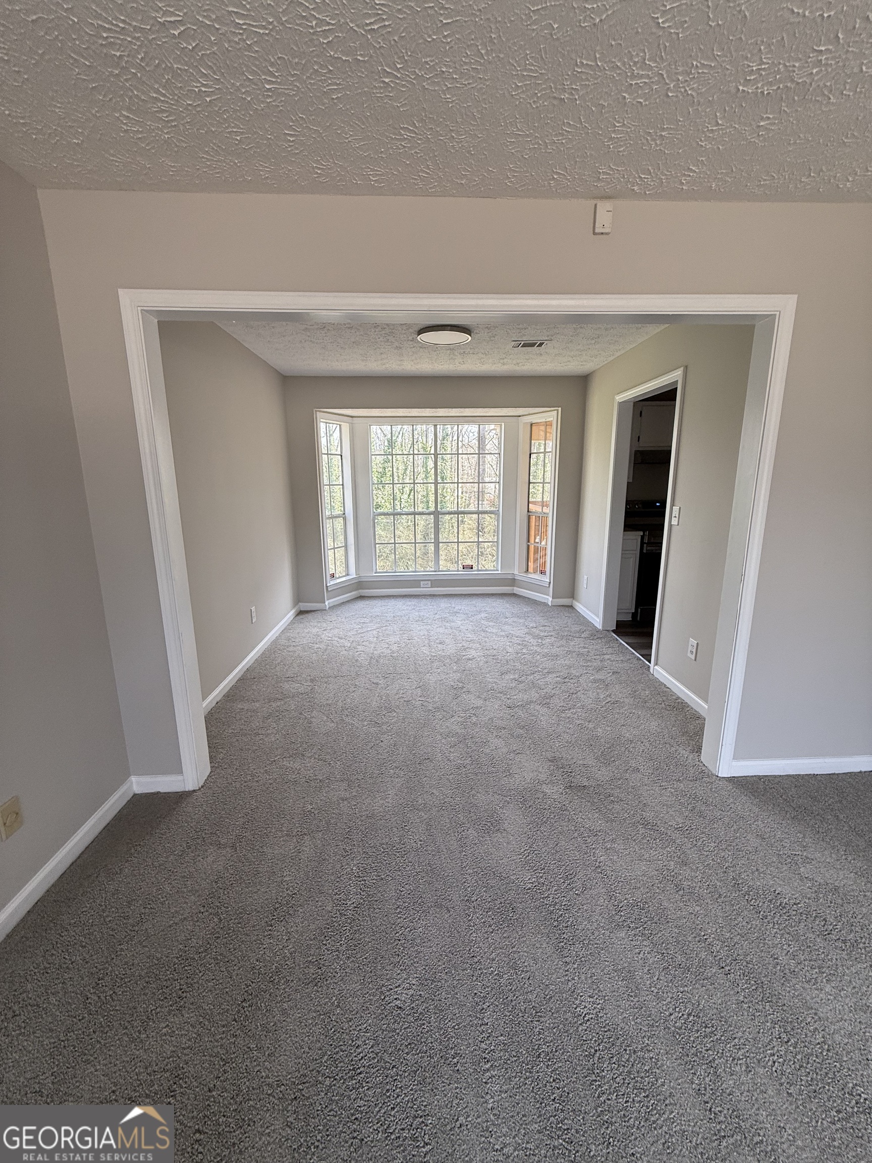 4144 Pinehurst Valley Drive Decatur, GA 30034 - Photo 4 of 31 a view of a big room with windows and chandelier fan