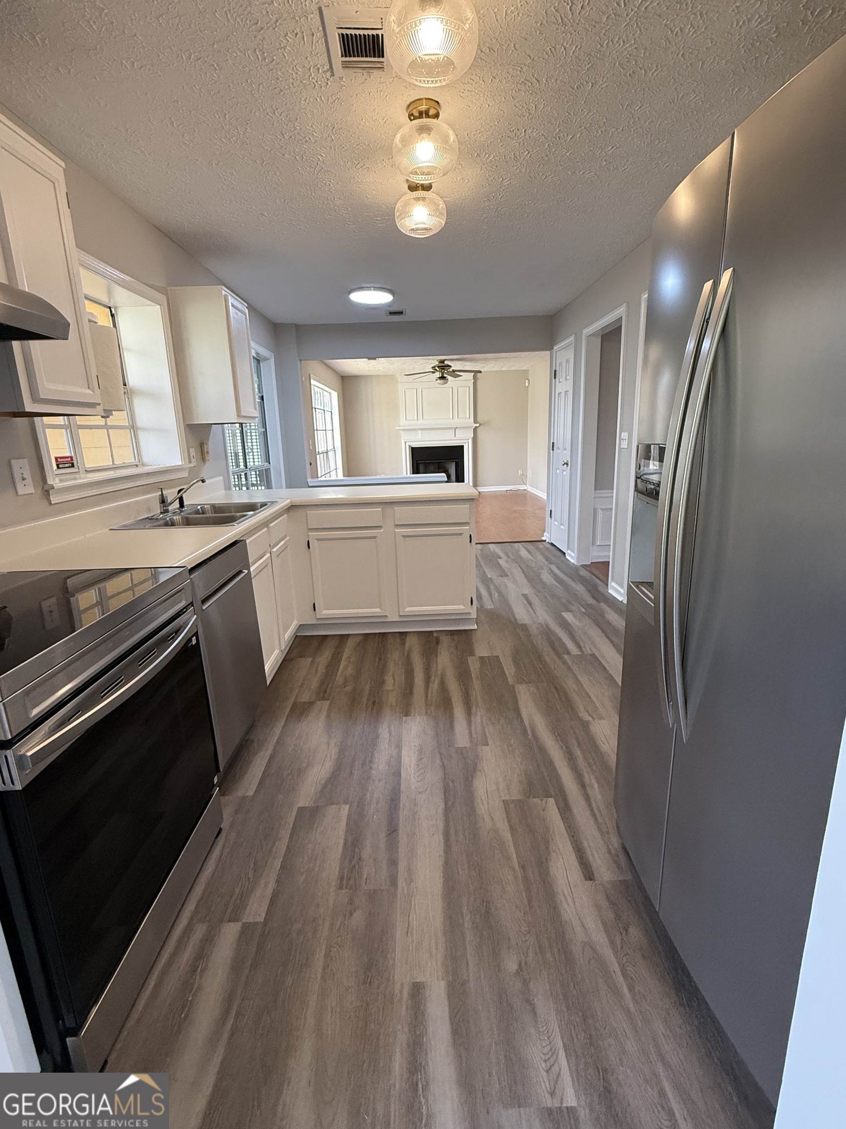 4144 Pinehurst Valley Drive Decatur, GA 30034 - Photo 5 of 31 a large kitchen with a sink and stainless steel appliances
