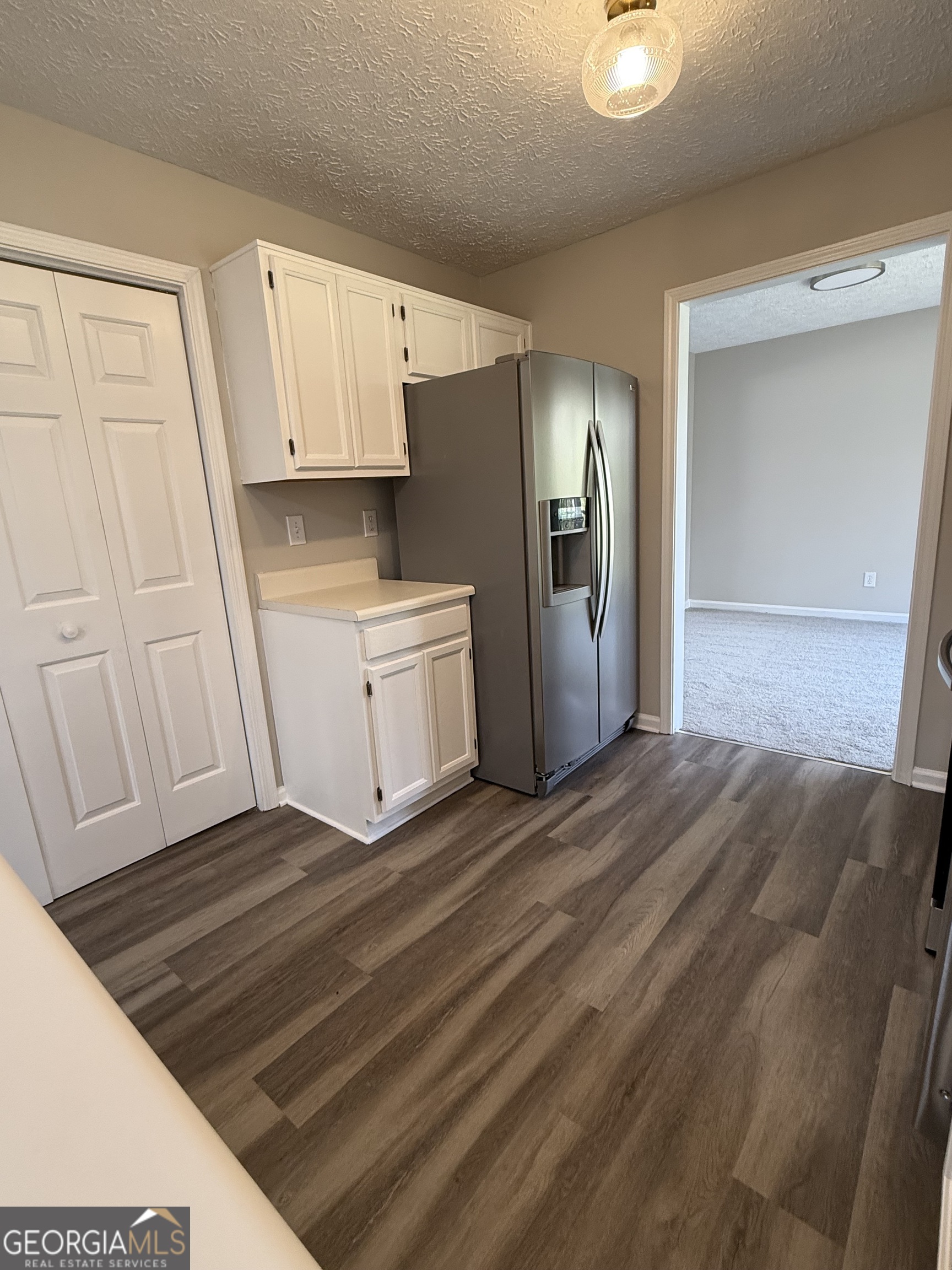 4144 Pinehurst Valley Drive Decatur, GA 30034 - Photo 6 of 31 a view of empty room with wooden floor and cabinet