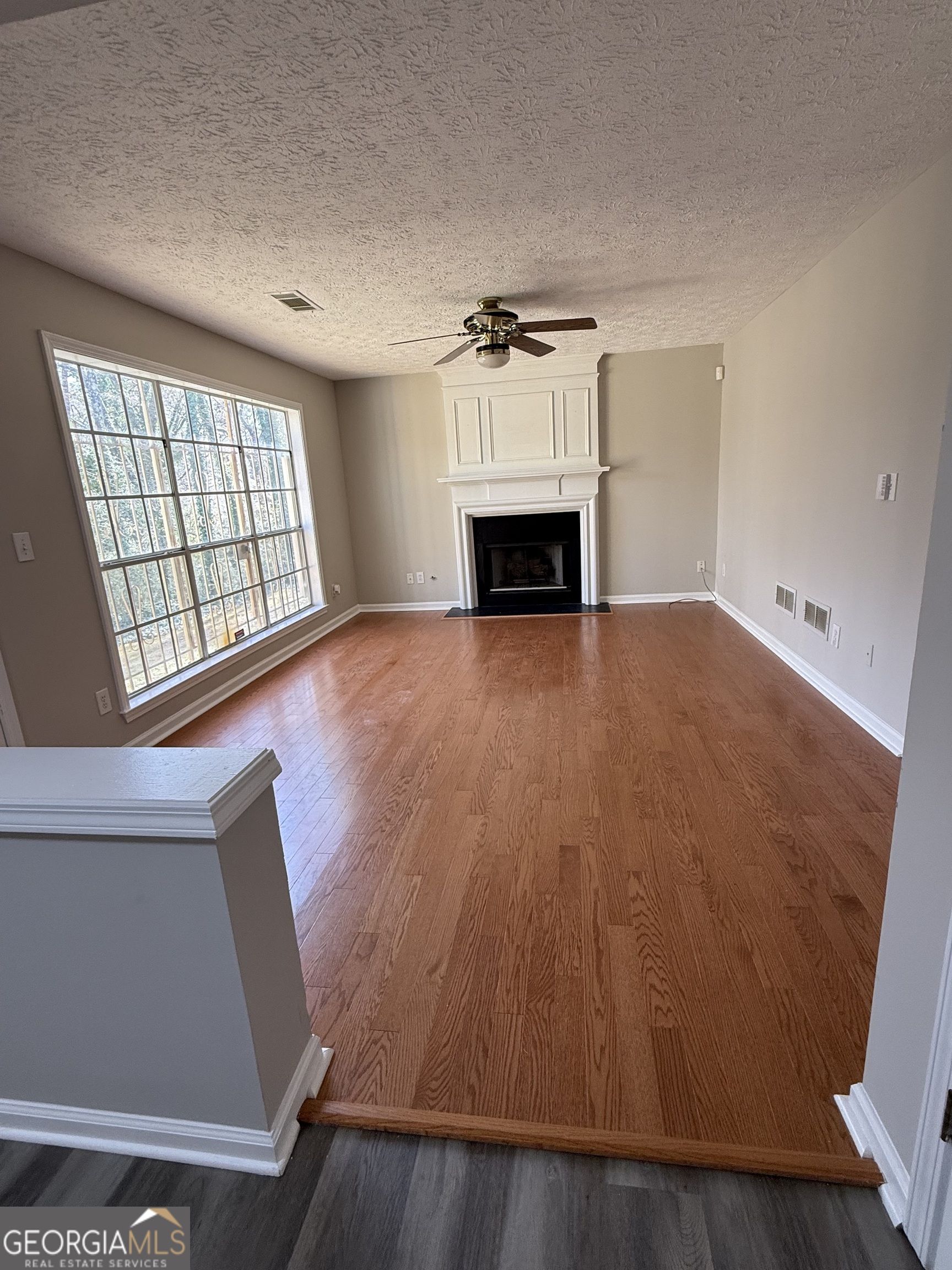 4144 Pinehurst Valley Drive Decatur, GA 30034 - Photo 7 of 31 an empty room with wooden floor and fireplace