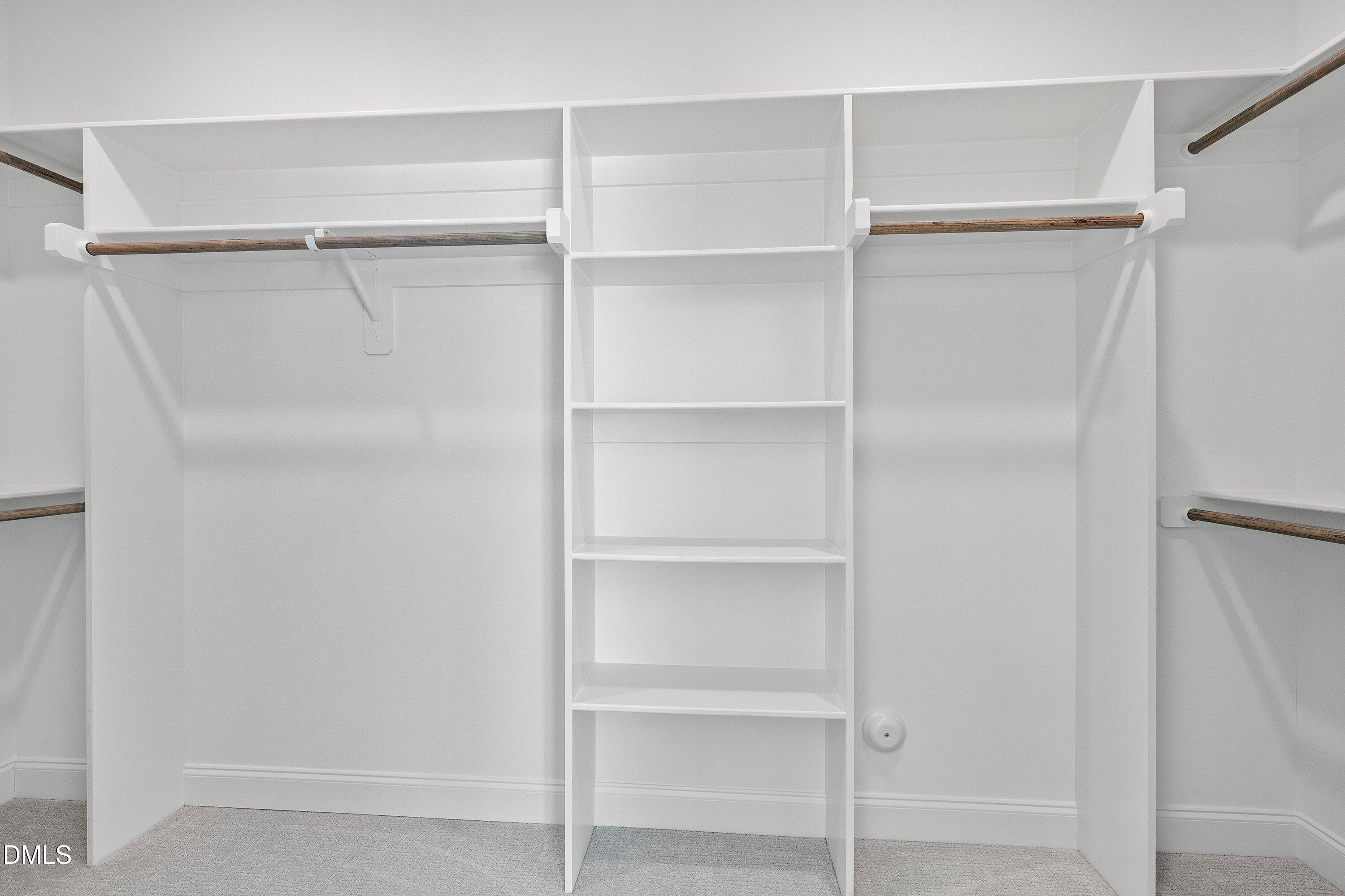 62 West Victoria Ridge Drive, Unit 19 Selma, NC 27576 - Photo 18 of 26 a view of walk in closet with empty racks