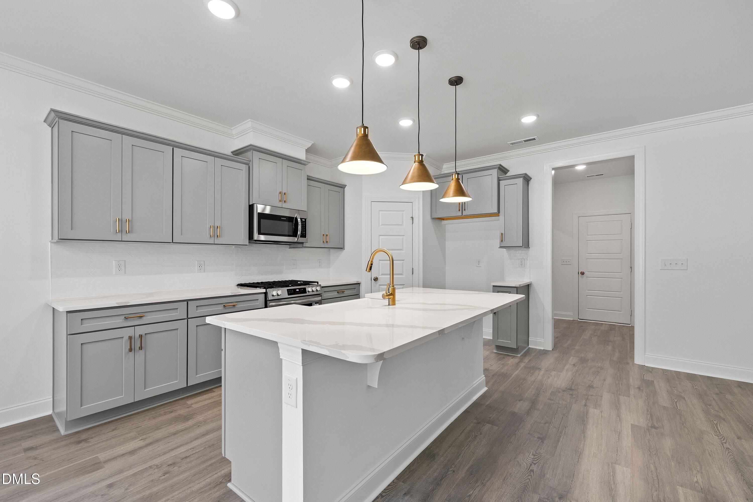 62 West Victoria Ridge Drive, Unit 19 Selma, NC 27576 - Photo 4 of 26 a kitchen with a sink cabinets and wooden floor