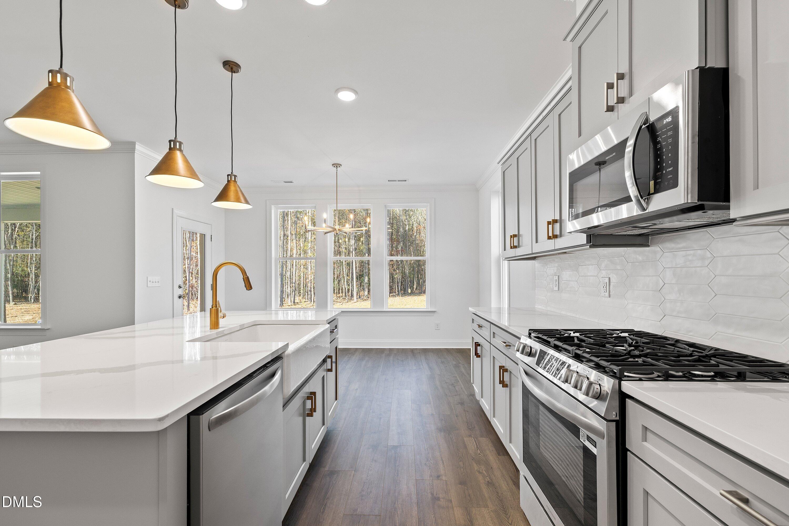 62 West Victoria Ridge Drive, Unit 19 Selma, NC 27576 - Photo 7 of 26 a kitchen with stainless steel appliances granite countertop a stove a sink and a wooden floors