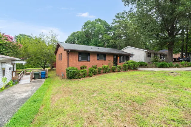 a view of a house with a yard patio and swimming pool