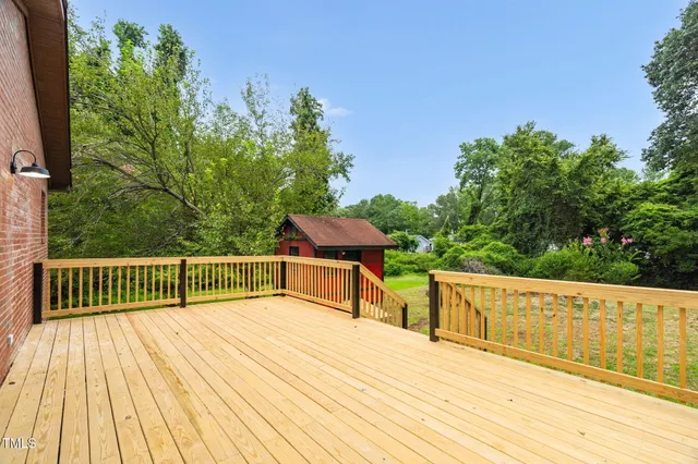 a view of a balcony with wooden floor and outdoor space