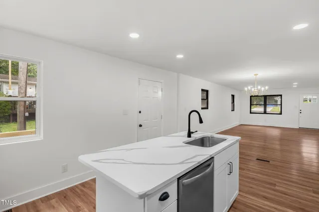 a kitchen with a sink and a refrigerator