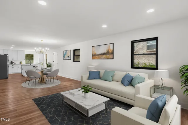 a living room with furniture and wooden floor