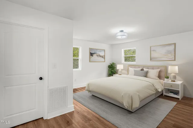 a bedroom with a bed and painting on the wall