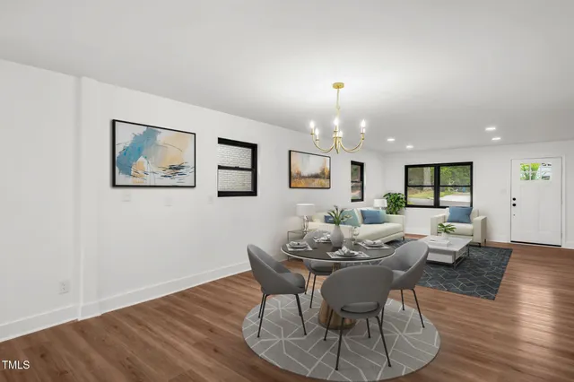 a living room with furniture a wooden floor and painting on the wall