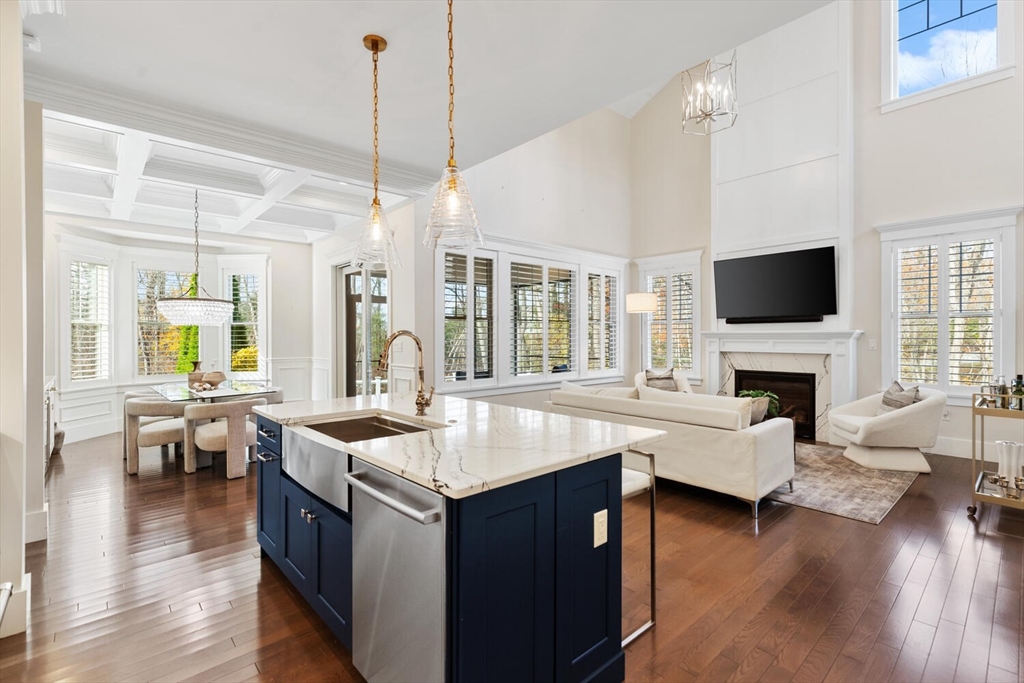 19 Gershon Way, Unit 1 Winchester, MA 01890 - Photo 15 of 42 a living room with fireplace furniture flat screen tv and wooden floor