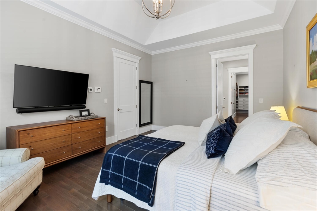 19 Gershon Way, Unit 1 Winchester, MA 01890 - Photo 21 of 42 a bedroom with a bed and flat screen tv