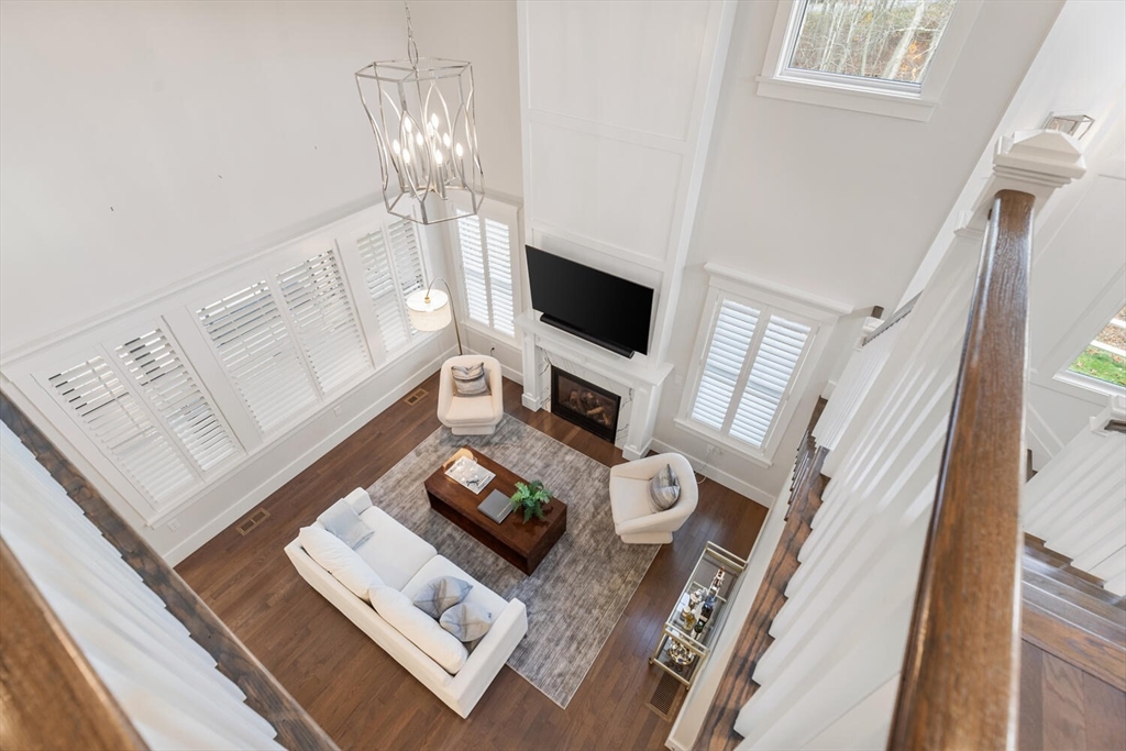 19 Gershon Way, Unit 1 Winchester, MA 01890 - Photo 30 of 42 a living room with furniture and a flat screen tv