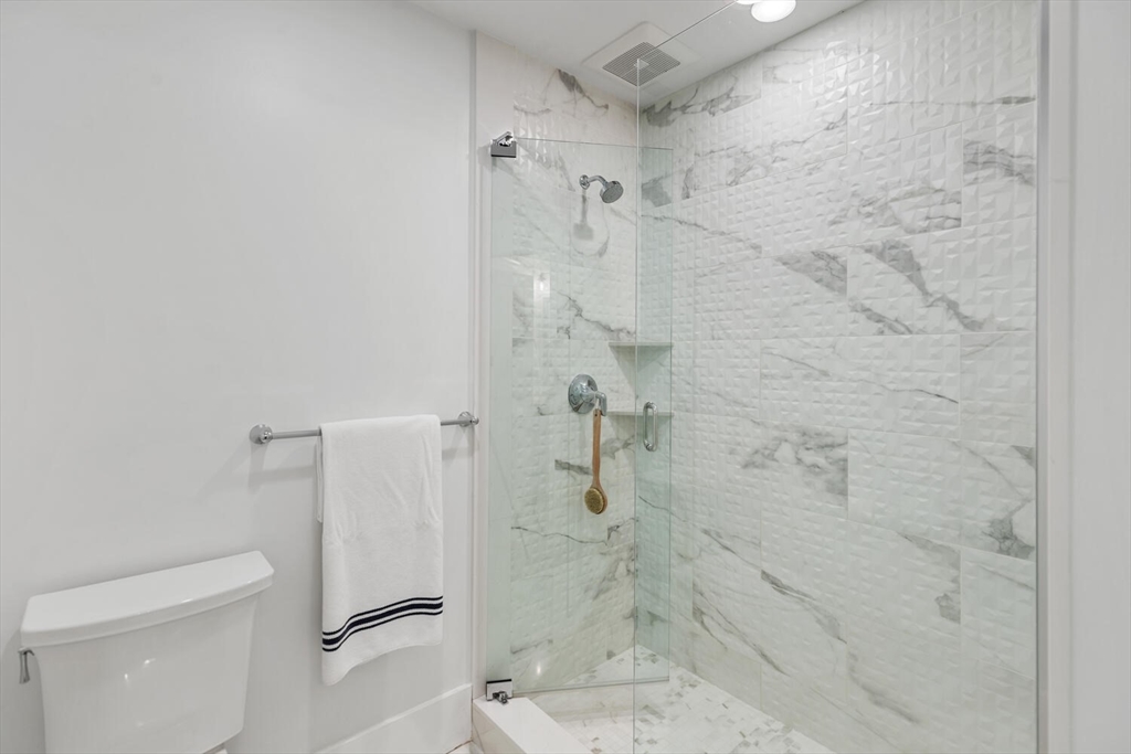 19 Gershon Way, Unit 1 Winchester, MA 01890 - Photo 33 of 42 a bathroom with a shower and toilet