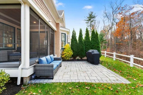 a view of a patio with couches chairs and a potted plant