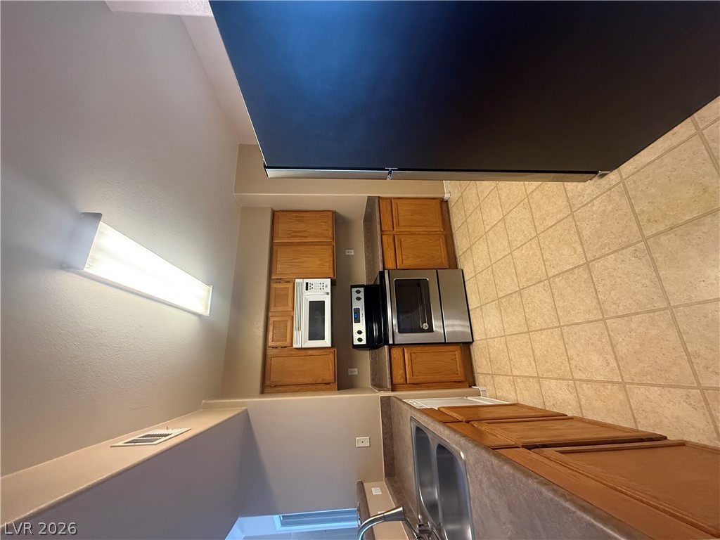 7255 West Sunset Road, Unit 2052 Las Vegas, NV 89113 - Photo 8 of 16 Functional kitchen with ample cabinetry and essential appliances for everyday living.