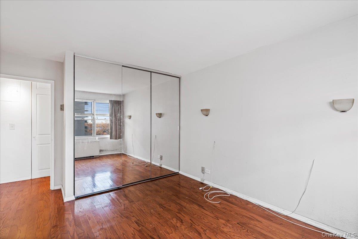 17-85 215th Street, Unit 5L Queens, NY 11360 - Photo 11 of 46 a view of a hallway with wooden floor
