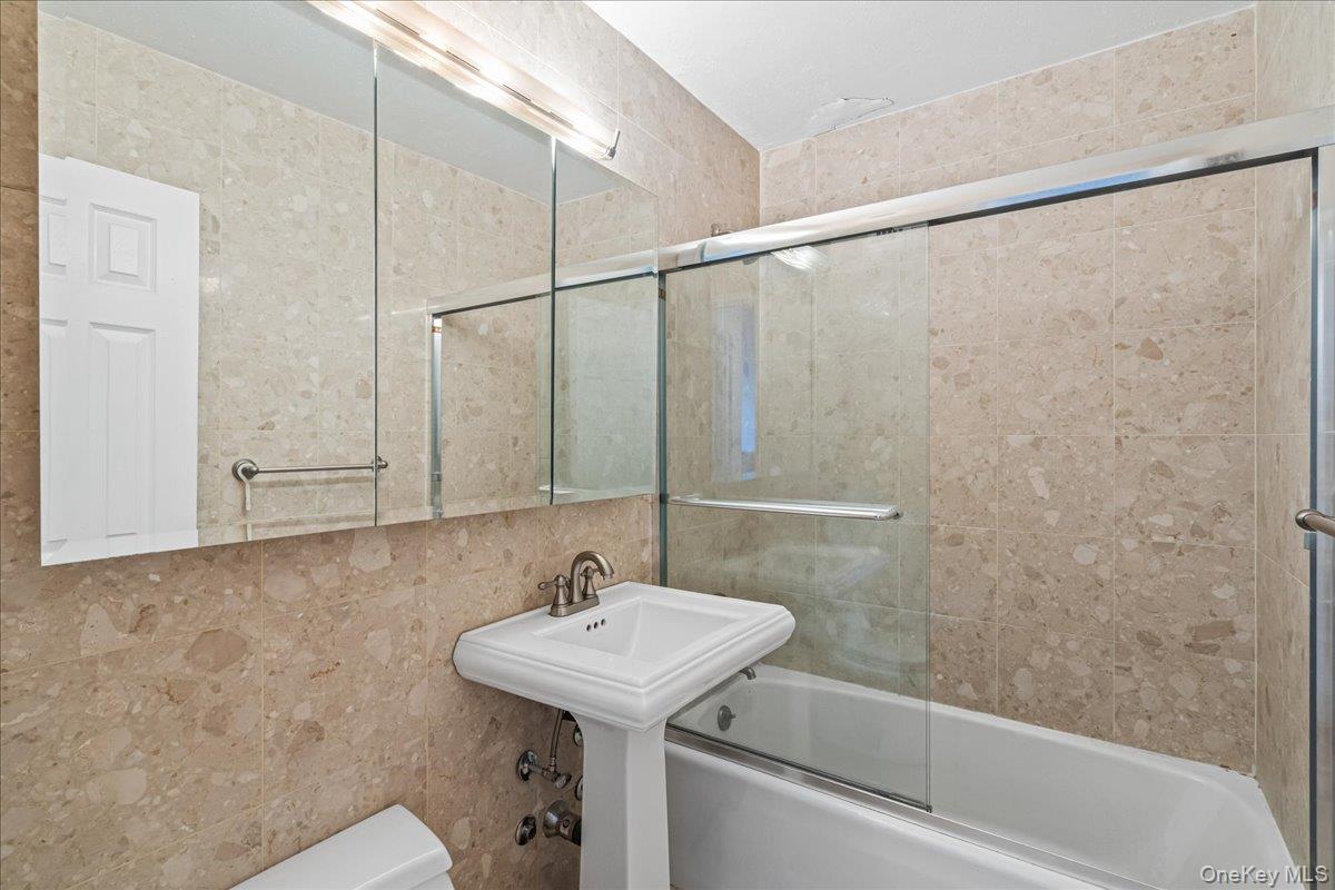 17-85 215th Street, Unit 5L Queens, NY 11360 - Photo 12 of 46 a bathroom with a sink and a bathtub