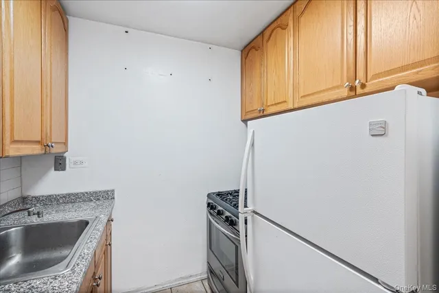 a kitchen with a sink appliances and cabinets