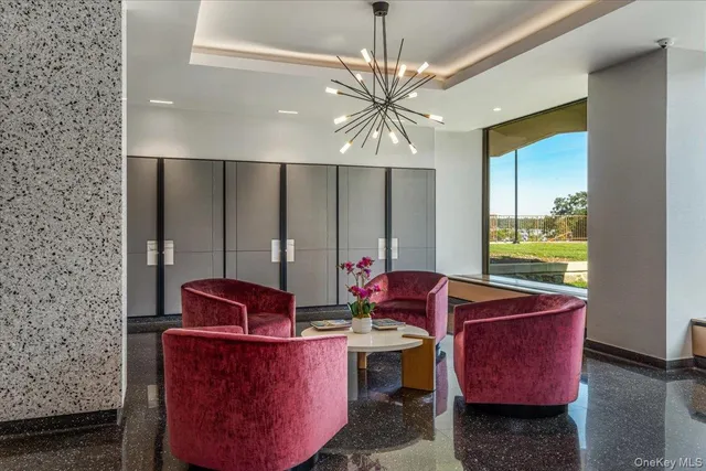 a living room with furniture and a chandelier