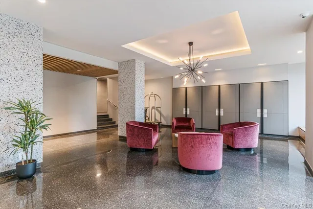 a living room with furniture gym equipment and a chandelier