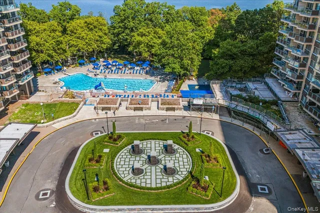 a swimming pool with outdoor seating and yard