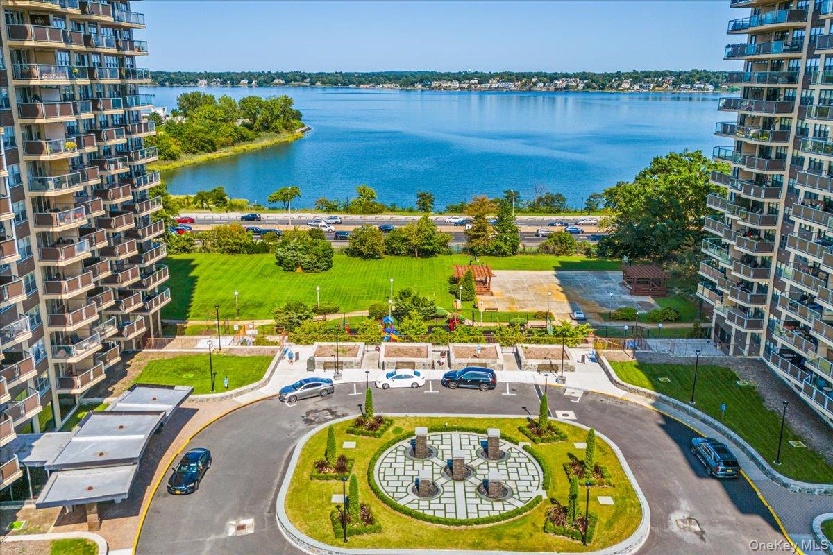 17-85 215th Street, Unit 5L Queens, NY 11360 - Photo 37 of 46 a swimming pool with outdoor seating and yard