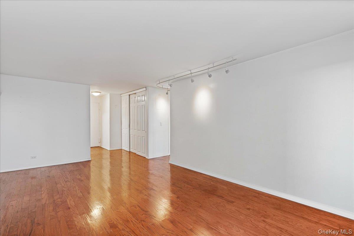 17-85 215th Street, Unit 5L Queens, NY 11360 - Photo 6 of 46 a view of an empty room with wooden floor