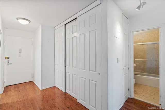 a view of a hallway with wooden floor
