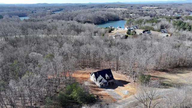 an aerial view of a house with a yard