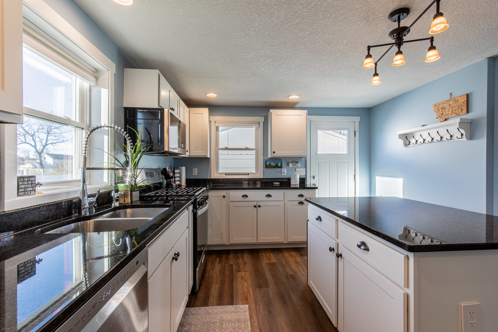220 2nd Street Wyanet, IL 61379 - Photo 9 of 27 a kitchen with granite countertop a sink stove and cabinets