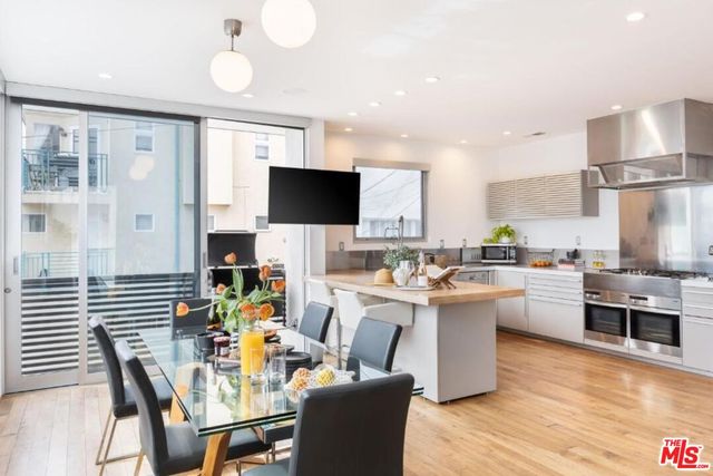 a living room with lots of furniture and kitchen view