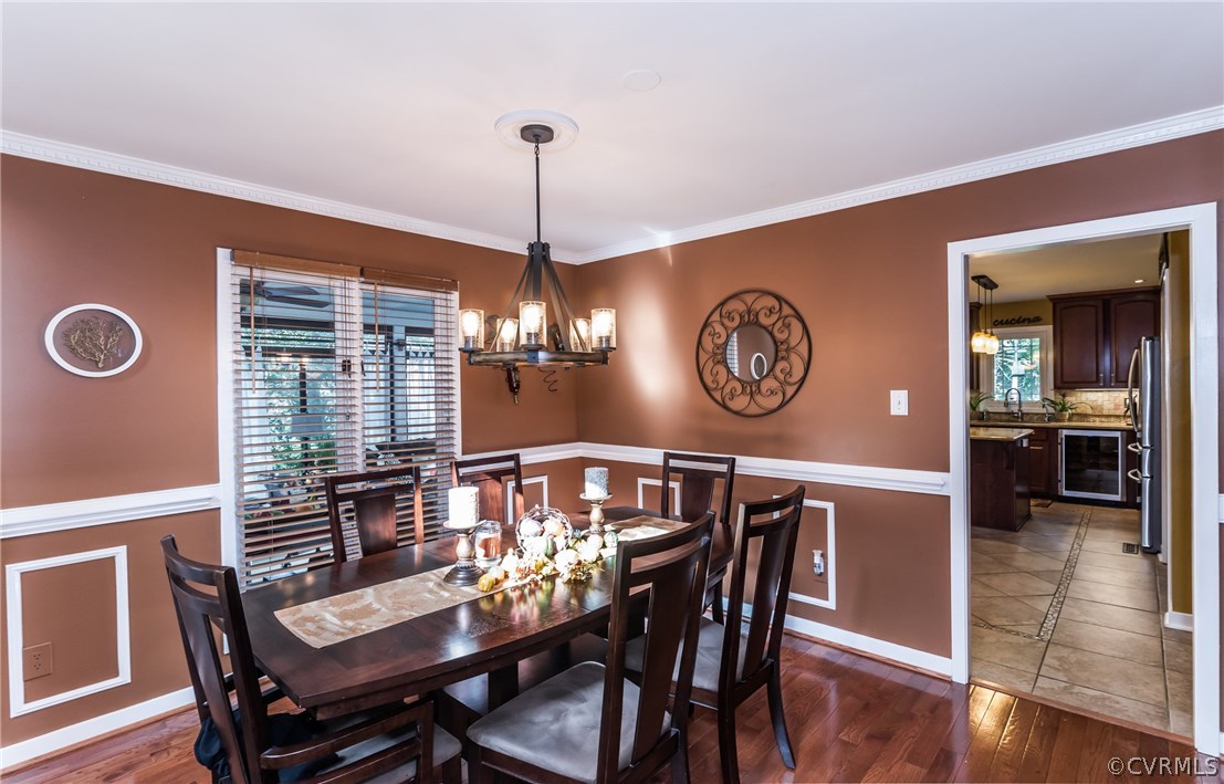 3216 Fortunes Ridge Road Midlothian, VA 23112 - Photo 13 of 41 a view of a dining room with furniture a chandelier and wooden floor