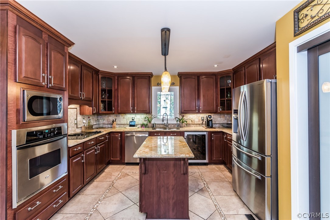 3216 Fortunes Ridge Road Midlothian, VA 23112 - Photo 18 of 41 a kitchen with stainless steel appliances granite countertop a stove top oven a sink dishwasher a refrigerator and cabinets with wooden floor