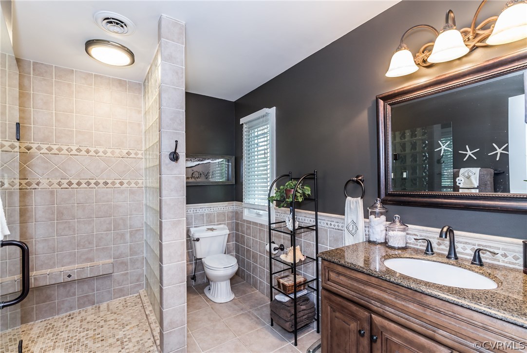 3216 Fortunes Ridge Road Midlothian, VA 23112 - Photo 28 of 41 a spacious bathroom with a granite countertop sink a toilet and shower