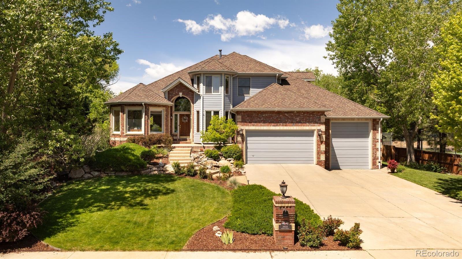 3935 Pierson Street Wheat Ridge, CO 80033 - Photo 1 of 50 a front view of a house with a yard and garage