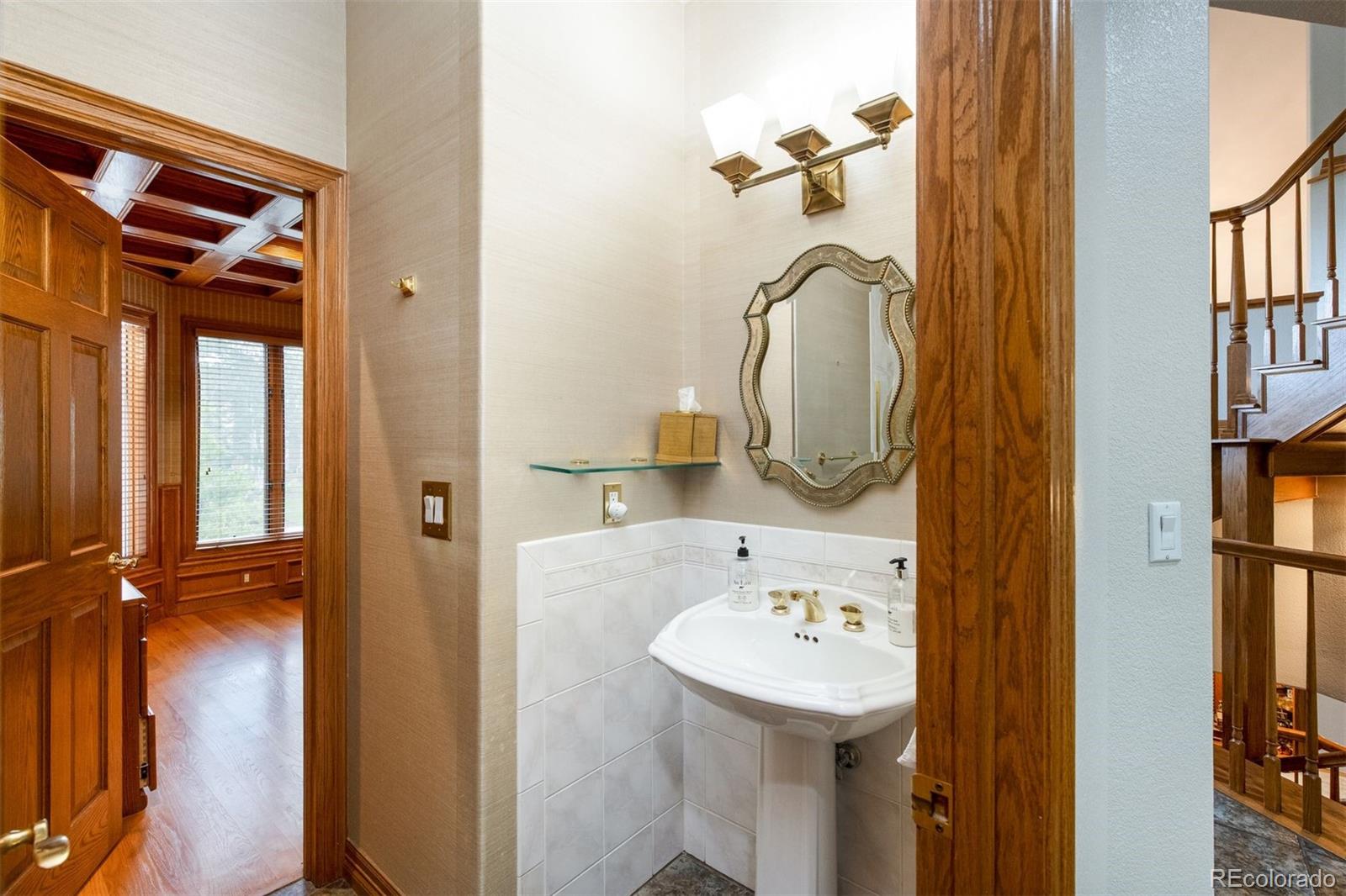3935 Pierson Street Wheat Ridge, CO 80033 - Photo 22 of 50 a bathroom with a sink and a mirror